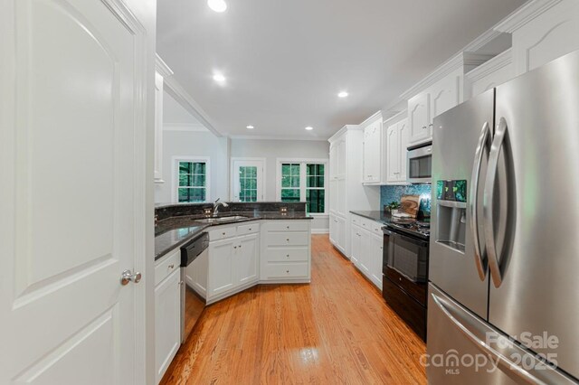 6414 Winding Creek Ln, Denver, NC 28037 - kitchen with appliances with stainless steel finishes, a sink, white cabinets, light wood-type flooring, and ornamental molding