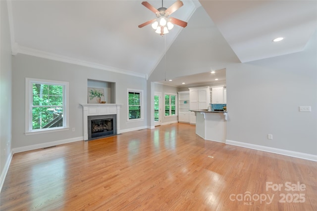 6414 Winding Creek Ln, Denver, NC 28037 - unfurnished living room with baseboards, a fireplace with flush hearth, high vaulted ceiling, a ceiling fan, and light wood-type flooring