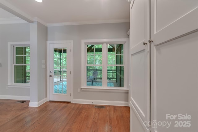 6414 Winding Creek Ln, Denver, NC 28037 - doorway with ornamental molding, light wood-style flooring, and baseboards