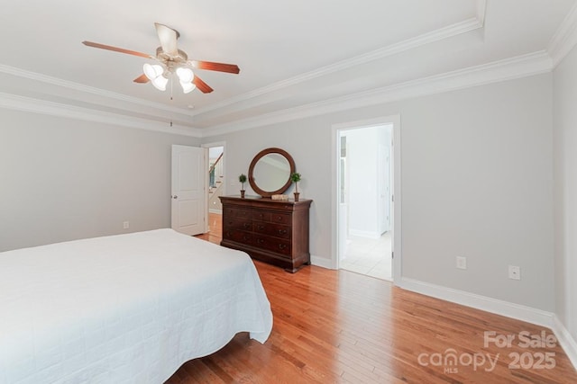 6414 Winding Creek Ln, Denver, NC 28037 - bedroom with light wood-style flooring, ornamental molding, baseboards, a raised ceiling, and a ceiling fan