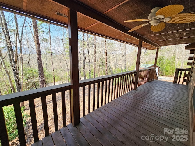 wooden deck with a ceiling fan