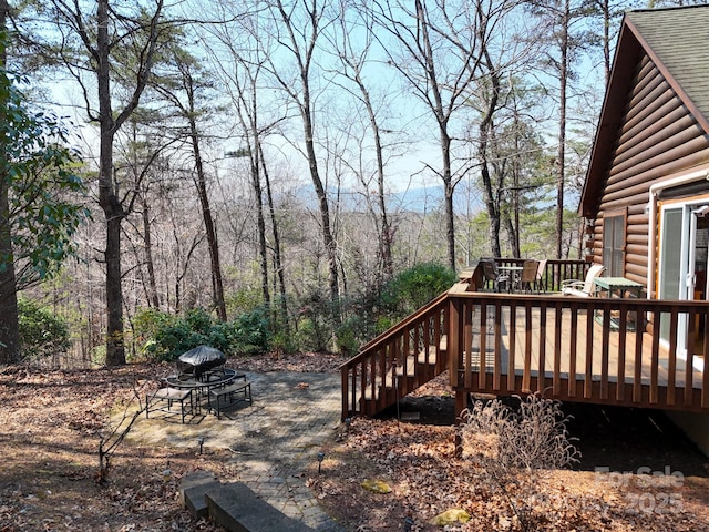 wooden terrace with a fire pit