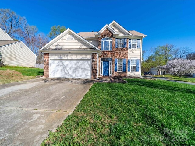 14802 Rolling Sky Dr, Charlotte, NC 28273 - view of front of home with brick siding, driveway, an attached garage, and a front lawn