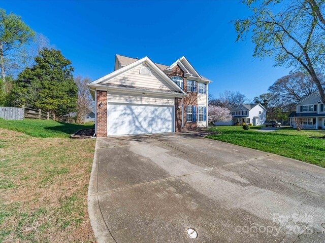 14802 Rolling Sky Dr, Charlotte, NC 28273 - traditional home with fence, a garage, concrete driveway, a front yard, and brick siding