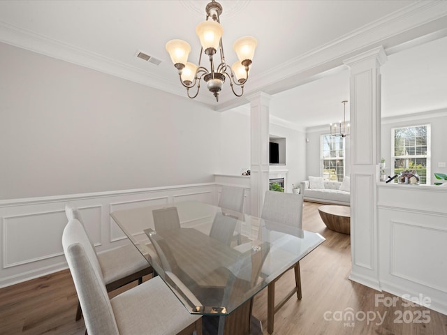 14802 Rolling Sky Dr, Charlotte, NC 28273 - dining area with ornate columns, a fireplace, visible vents, and a chandelier