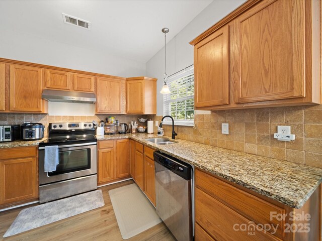 14802 Rolling Sky Dr, Charlotte, NC 28273 - kitchen with a sink, tasteful backsplash, appliances with stainless steel finishes, under cabinet range hood, and visible vents
