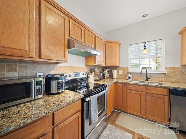 14802 Rolling Sky Dr, Charlotte, NC 28273 - kitchen featuring light stone counters, a sink, tasteful backsplash, appliances with stainless steel finishes, and under cabinet range hood