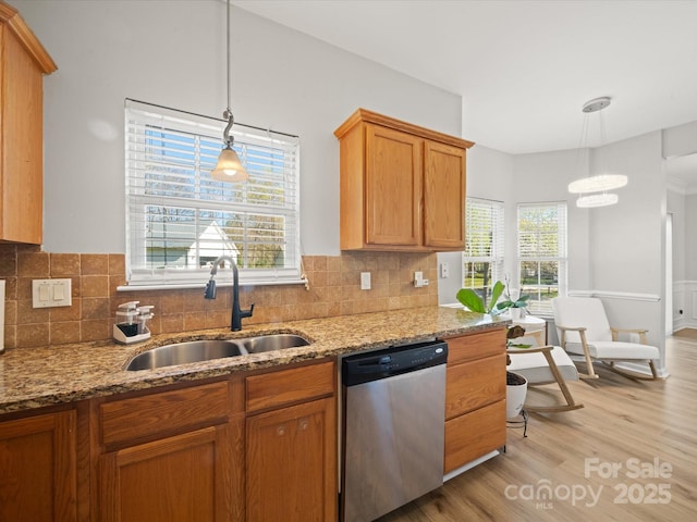 14802 Rolling Sky Dr, Charlotte, NC 28273 - kitchen with light stone counters, a sink, stainless steel dishwasher, light wood-style flooring, and decorative backsplash