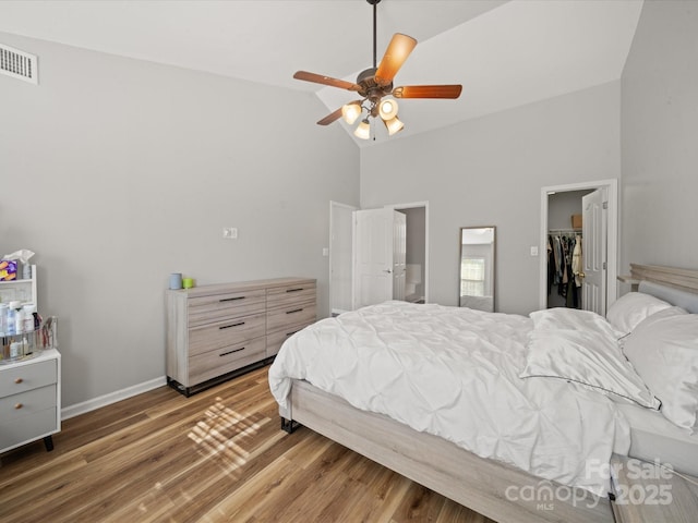 14802 Rolling Sky Dr, Charlotte, NC 28273 - bedroom featuring high vaulted ceiling, a closet, wood finished floors, a spacious closet, and visible vents