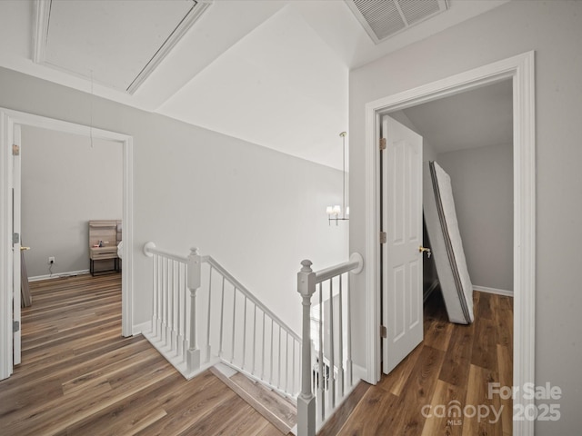 14802 Rolling Sky Dr, Charlotte, NC 28273 - hall featuring attic access, visible vents, wood finished floors, and an upstairs landing