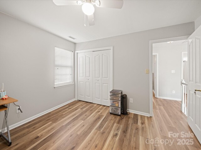 14802 Rolling Sky Dr, Charlotte, NC 28273 - unfurnished bedroom with a closet, visible vents, baseboards, ceiling fan, and wood finished floors