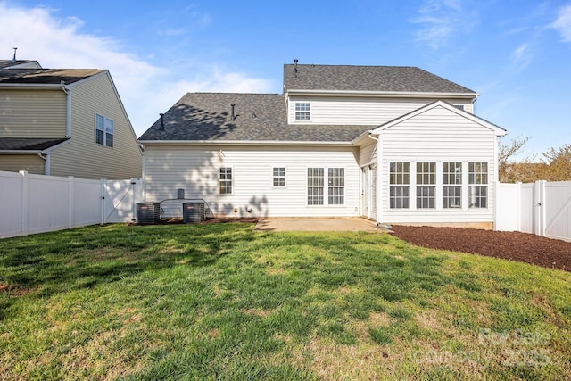back of property featuring a lawn, a fenced backyard, a gate, a shingled roof, and a patio area