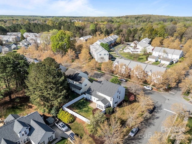 bird's eye view featuring a residential view and a wooded view