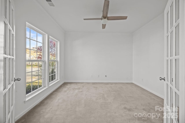 unfurnished room featuring french doors, carpet, baseboards, ceiling fan, and visible vents