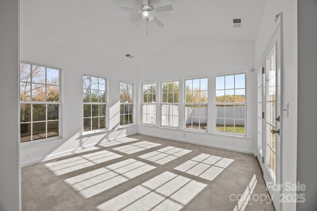 unfurnished sunroom with baseboards, visible vents, high vaulted ceiling, and carpet flooring