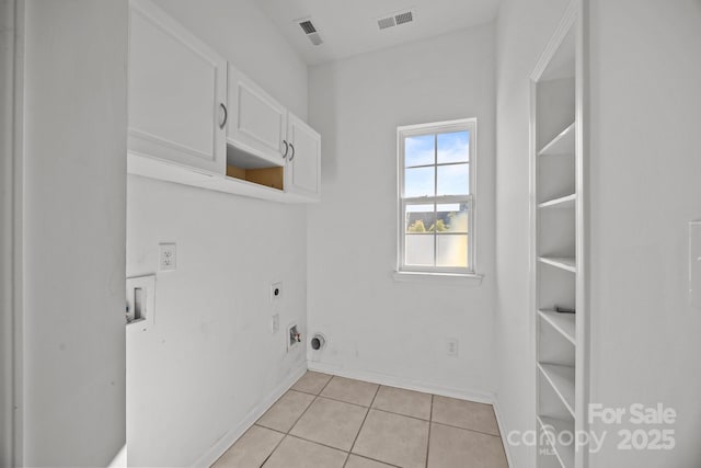 clothes washing area featuring cabinet space, visible vents, hookup for an electric dryer, and light tile patterned floors