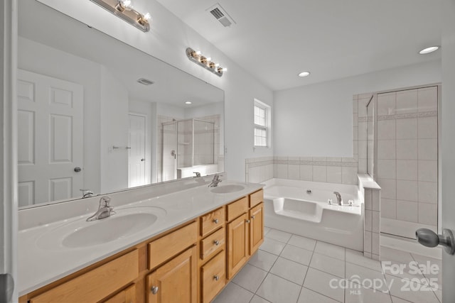 full bath featuring a stall shower, a sink, tile patterned flooring, a bath, and visible vents