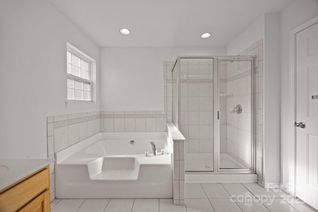 full bathroom with a shower stall, recessed lighting, vanity, a garden tub, and tile patterned flooring