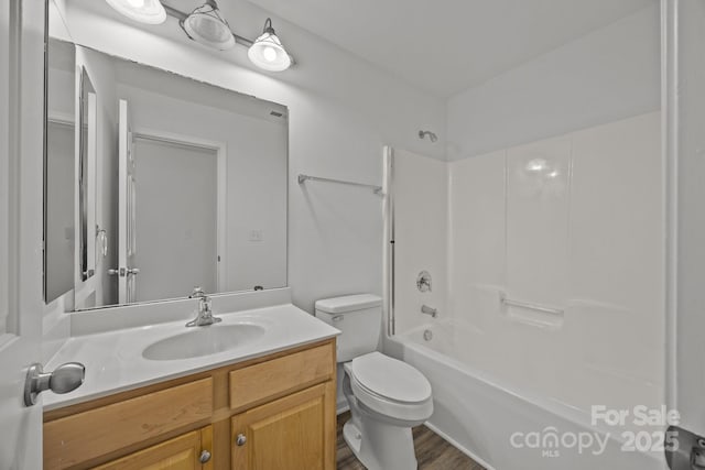bathroom with toilet, vanity, and shower / tub combination