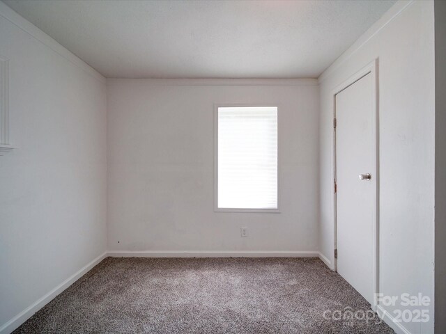 2300 Kennesaw Dr, Charlotte, NC 28216 - unfurnished bedroom with baseboards and carpet