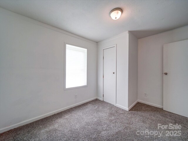 2300 Kennesaw Dr, Charlotte, NC 28216 - unfurnished bedroom featuring carpet floors and baseboards