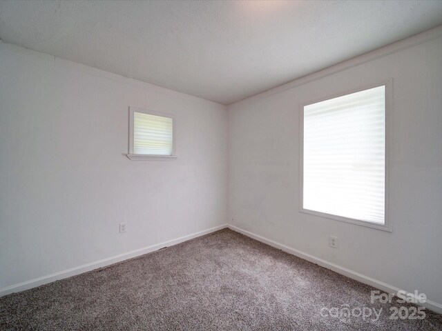 2300 Kennesaw Dr, Charlotte, NC 28216 - spare room featuring baseboards and carpet