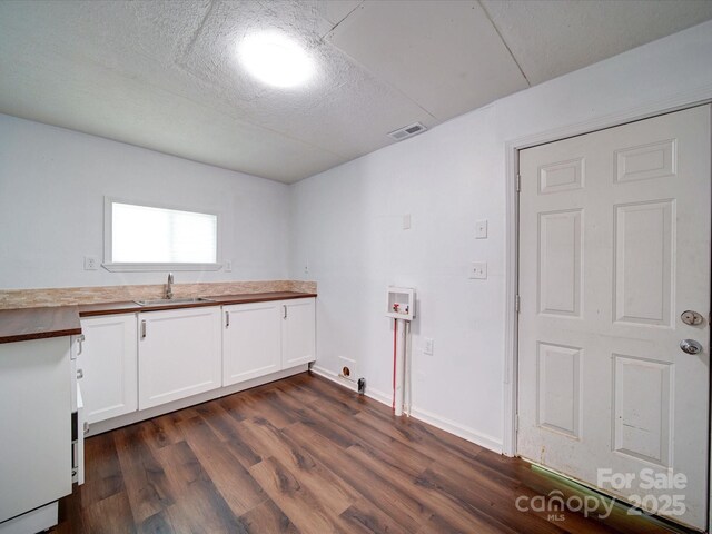 2300 Kennesaw Dr, Charlotte, NC 28216 - laundry room with visible vents, dark wood-type flooring, a sink, cabinet space, and washer hookup