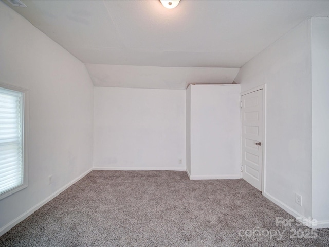 2300 Kennesaw Dr, Charlotte, NC 28216 - empty room featuring carpet floors, baseboards, and vaulted ceiling