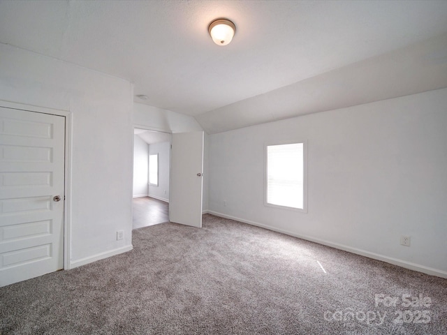 2300 Kennesaw Dr, Charlotte, NC 28216 - spare room featuring carpet floors, baseboards, and vaulted ceiling