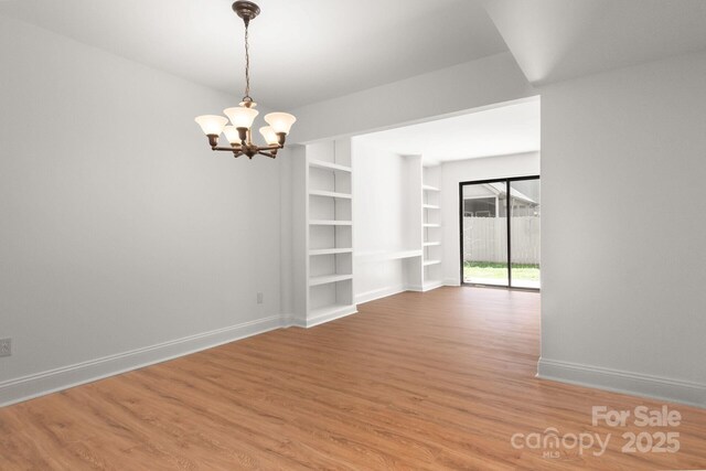3709 Willow Point Dr, Charlotte, NC 28277 - interior space with baseboards, light wood-type flooring, built in features, and a notable chandelier