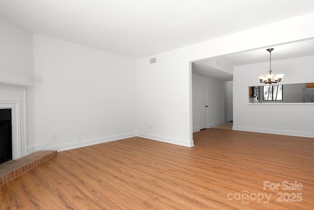 3709 Willow Point Dr, Charlotte, NC 28277 - unfurnished living room with baseboards, light wood-type flooring, visible vents, and an inviting chandelier