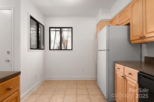 3709 Willow Point Dr, Charlotte, NC 28277 - kitchen featuring light brown cabinets, light tile patterned floors, dark countertops, and baseboards