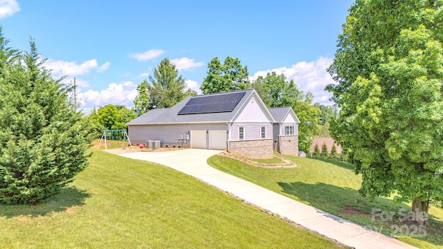 21 Willie Ln, Weaverville, NC 28787 - rear view of house with roof mounted solar panels, a lawn, concrete driveway, and brick siding