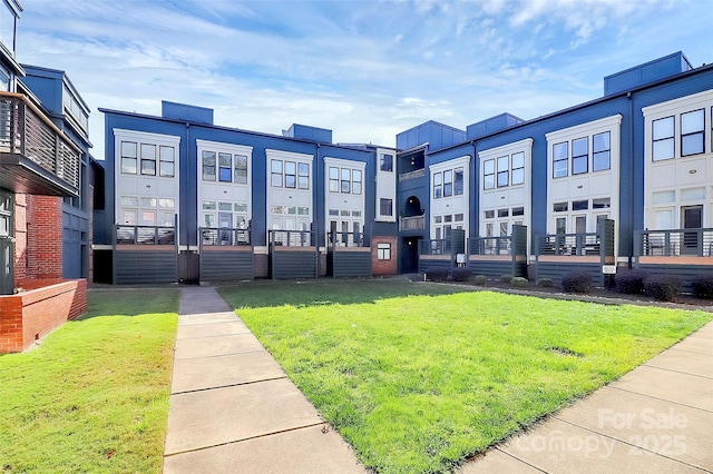 view of property's community featuring a residential view and a lawn