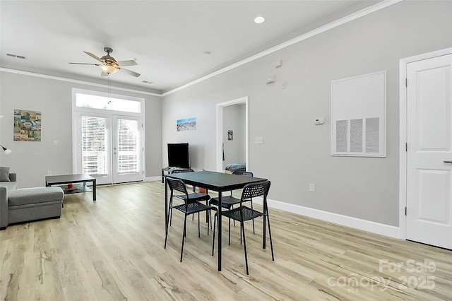 dining area featuring baseboards, crown molding, and a ceiling fan