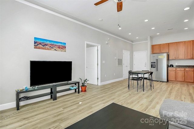 living area with baseboards, ornamental molding, ceiling fan, recessed lighting, and light wood-style floors
