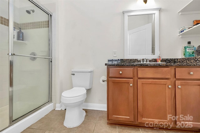 bathroom with a stall shower, toilet, tile patterned flooring, and vanity