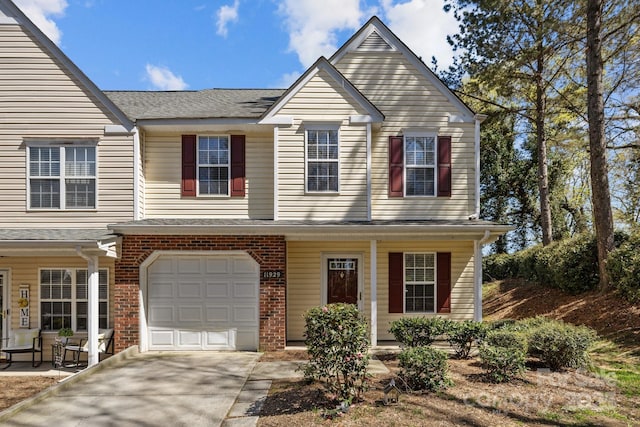 11929 Kings Castle Ct, Charlotte, NC 28277 - view of front of home featuring a garage, concrete driveway, brick siding, covered porch, and a shingled roof