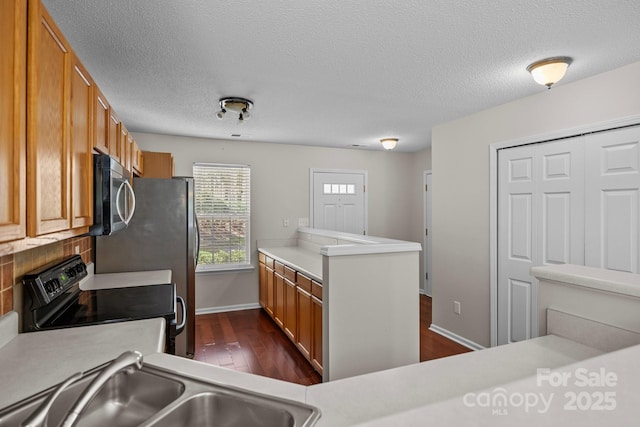 11929 Kings Castle Ct, Charlotte, NC 28277 - kitchen featuring light countertops, black / electric stove, a sink, stainless steel microwave, and dark wood-style flooring