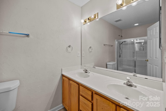 11929 Kings Castle Ct, Charlotte, NC 28277 - bathroom with double vanity, a sink, toilet, and a stall shower
