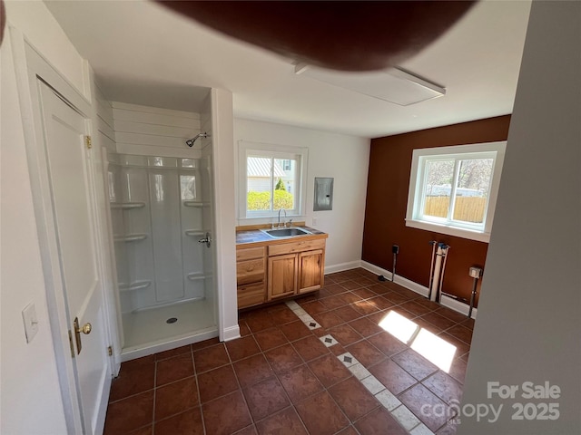 full bath featuring baseboards, tile patterned flooring, a shower stall, and plenty of natural light