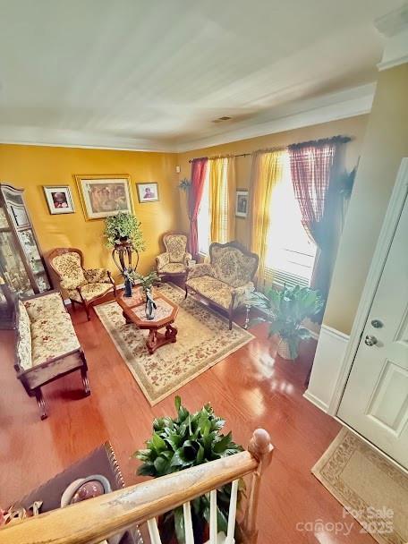 living room with wood finished floors and visible vents