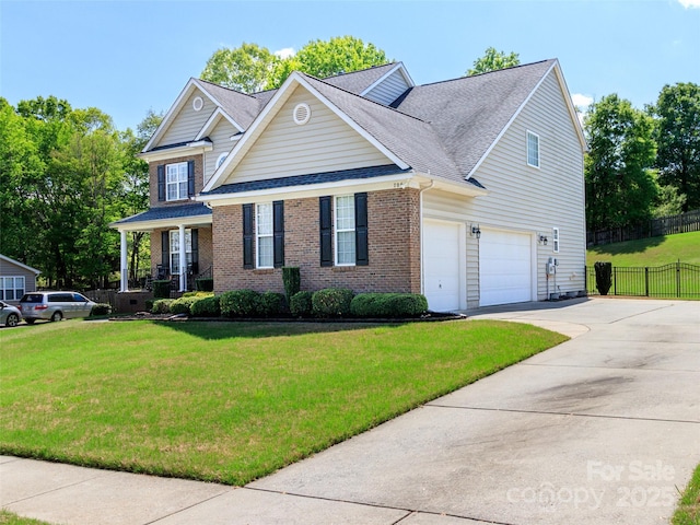 706 Springwood Dr Unit 14, Waxhaw, NC 28173 - view of front facade with a front yard, fence, brick siding, and driveway