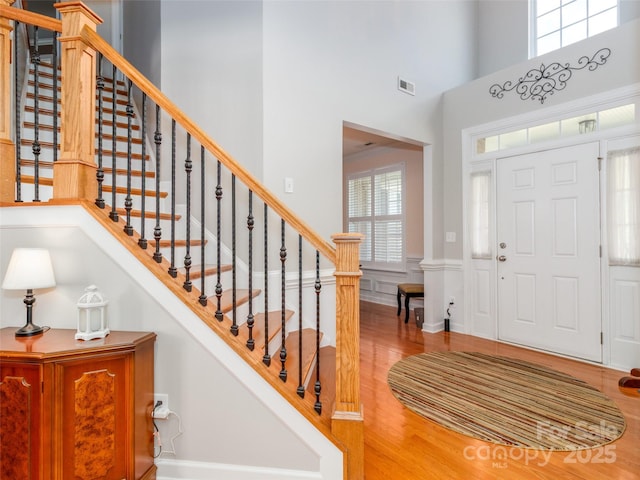 706 Springwood Dr Unit 14, Waxhaw, NC 28173 - entrance foyer with visible vents, a wainscoted wall, wood finished floors, a high ceiling, and stairs