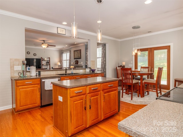 706 Springwood Dr Unit 14, Waxhaw, NC 28173 - kitchen with light wood-style floors, stainless steel dishwasher, a sink, and a kitchen island