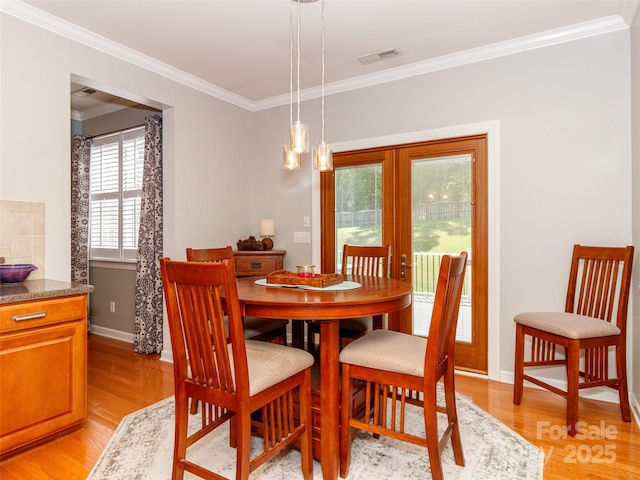 706 Springwood Dr Unit 14, Waxhaw, NC 28173 - dining area with light wood-style floors, visible vents, baseboards, and crown molding