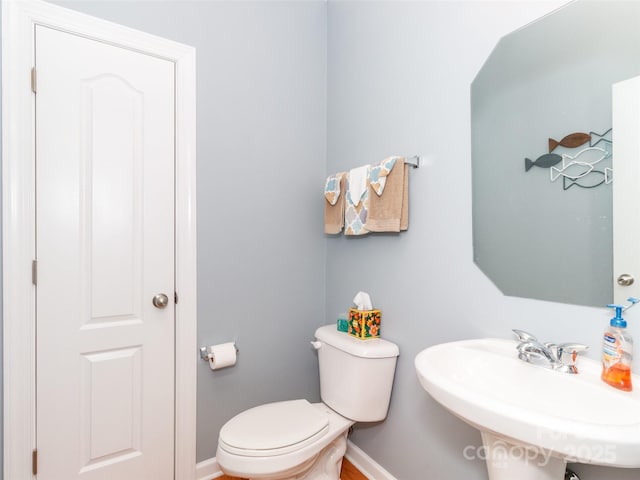 706 Springwood Dr Unit 14, Waxhaw, NC 28173 - bathroom featuring toilet, a sink, and baseboards