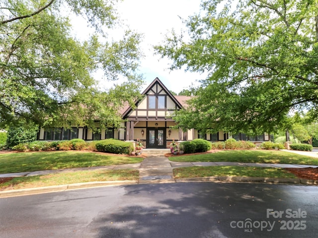 706 Springwood Dr Unit 14, Waxhaw, NC 28173 - tudor house with a front yard, french doors, and stucco siding