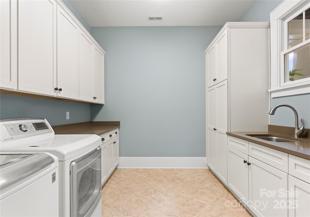 18420 Rosapenny Rd, Charlotte, NC 28278 - laundry area featuring cabinet space, washer and clothes dryer, and baseboards