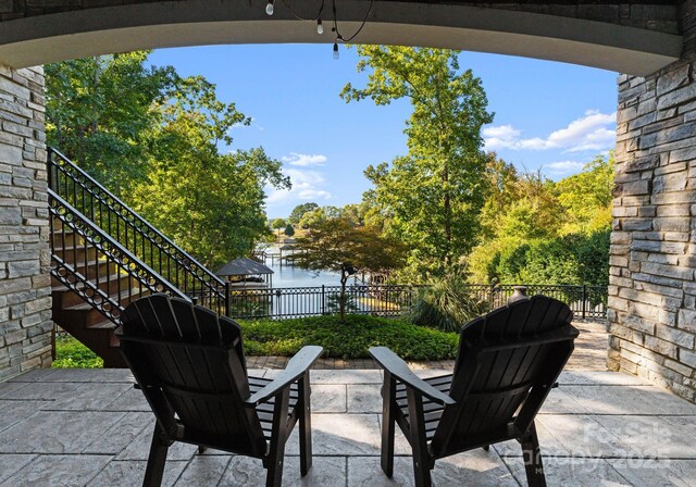 18420 Rosapenny Rd, Charlotte, NC 28278 - view of patio with stairs, fence, and a water view